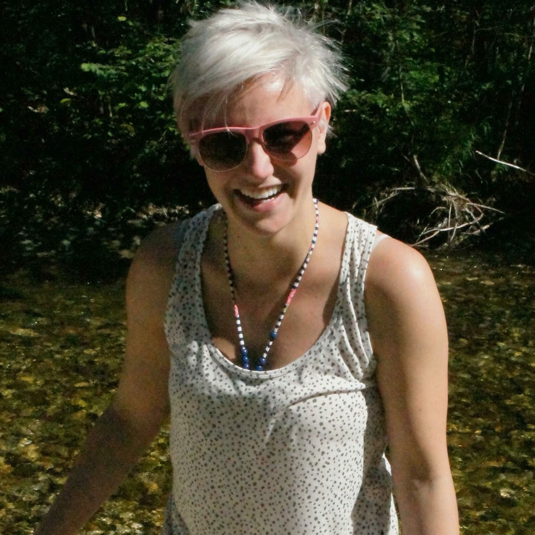 A woman wearing sunglasses posing for the camera